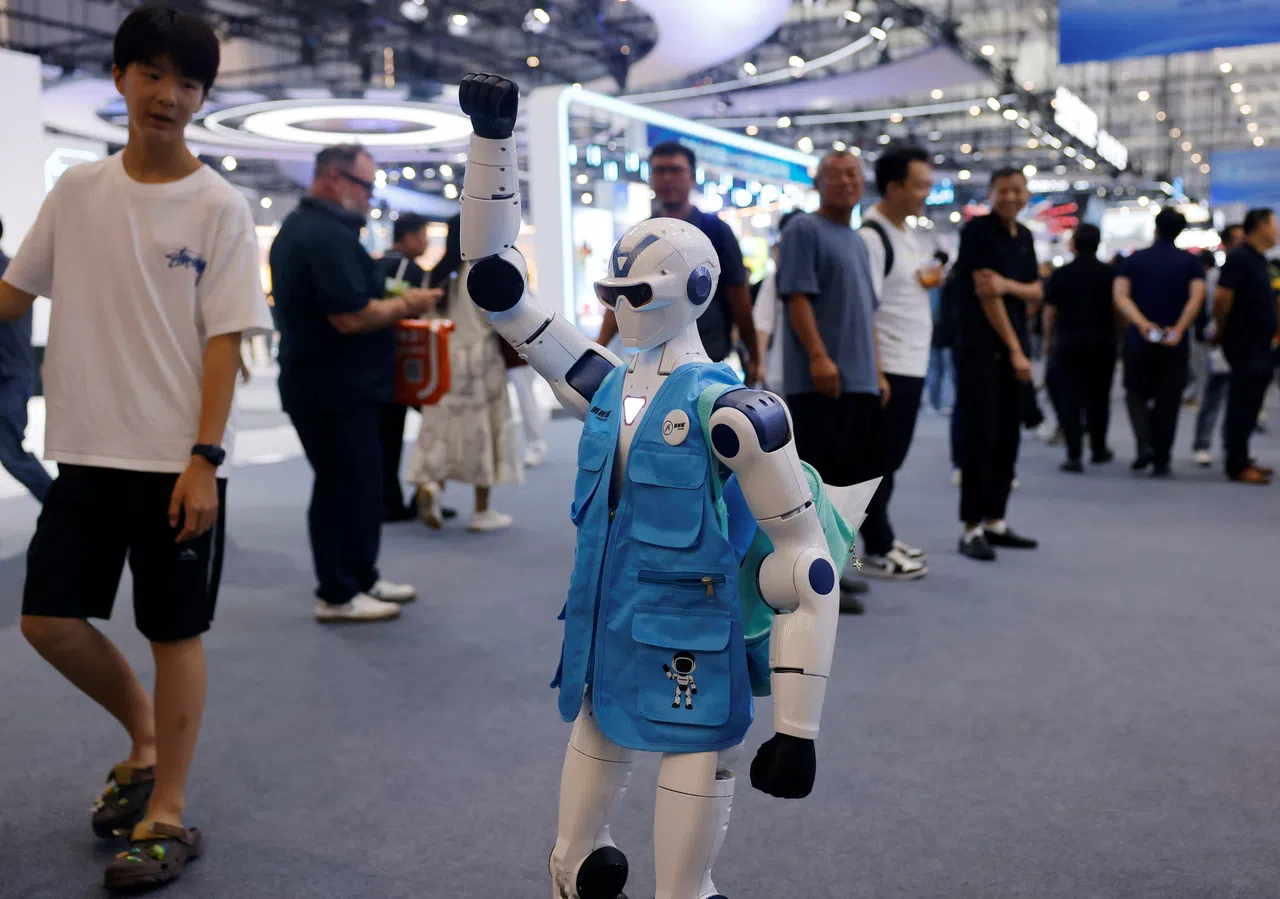 People look at a Unitree R1 robot wearing a branded vest at the 2026 World Robot Conference, in Beijing, China, on 20 August 2026.