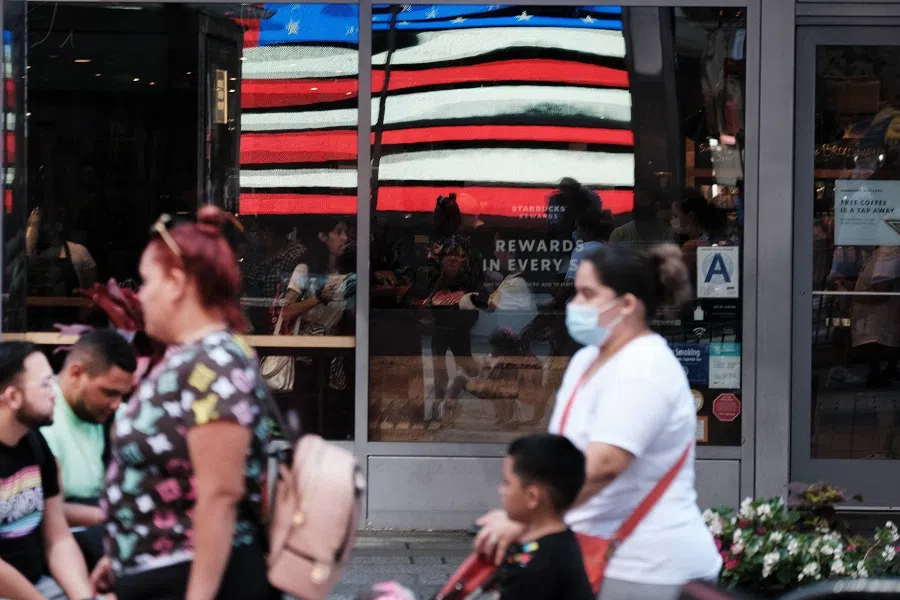 People move through Times Square on 28 June 2021 in New York City, US. (Spencer Platt/Getty Images/AFP)