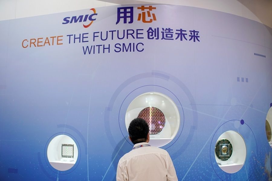 A man visits a Semiconductor Manufacturing International Corporation (SMIC) booth, at China International Semiconductor Expo, in Shanghai, China, 14 October 2020. (Aly Song/Reuters)