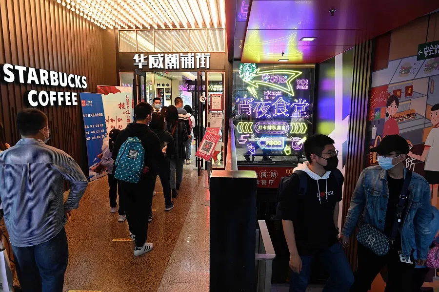People wait to enter a shopping mall during the country's Golden Week holiday in Beijing, China, on 2 October 2021. (Jade Gao/AFP)