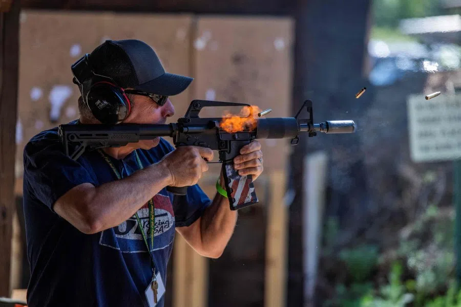 A man fires an automatic weapon at the Hillsborough County Republican Committee’s Annual Machine Gun Shoot at the Londonderry Fish & Game Club in Litchfield, New Hampshire, on 2 August 2025. (Joseph Prezioso/AFP)