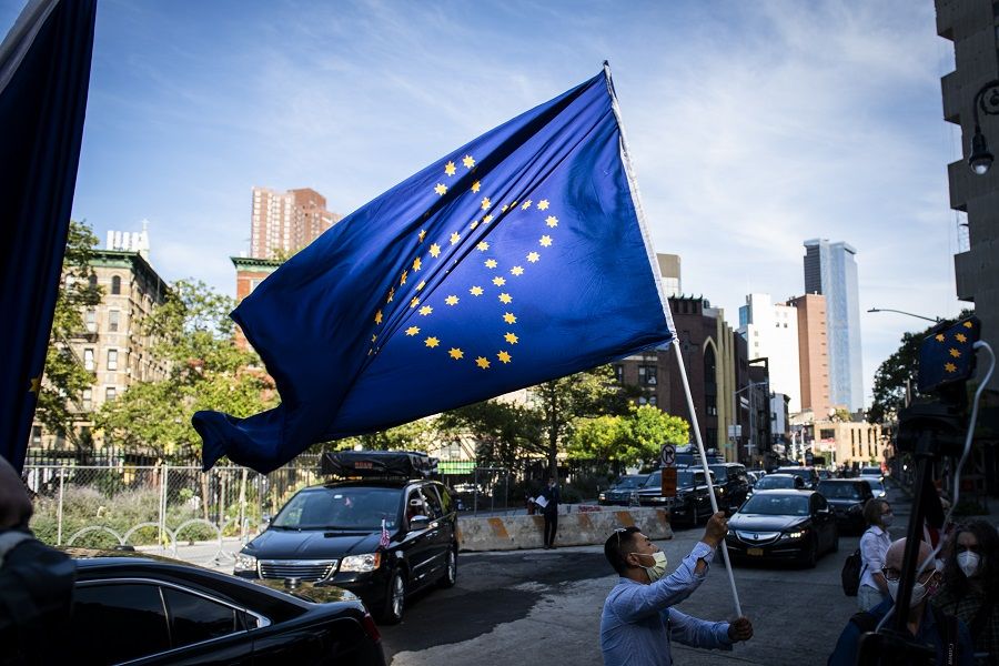 A supporter of the New Federal State of China waves a flag as they wait for Steve Bannon to depart from federal court in New York, US, on 20 August 2020. (Mark Kauzlarich/Bloomberg)