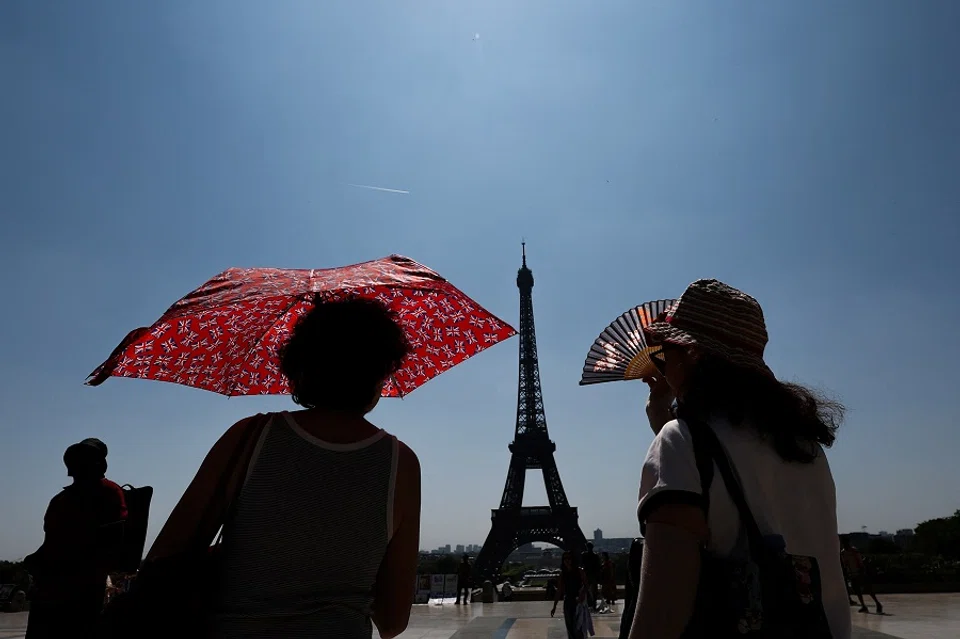 Tourists near the Eiffel Tower in Paris, France, on 19 June 2025. (Gonzalo Fuentes/Reuters)