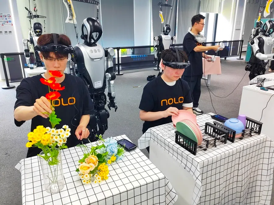 Data trainers collect data on flower arranging and kitchen utensil organisation at the Shijingshan Humanoid Robot Data Training Centre on 13 August 2026.