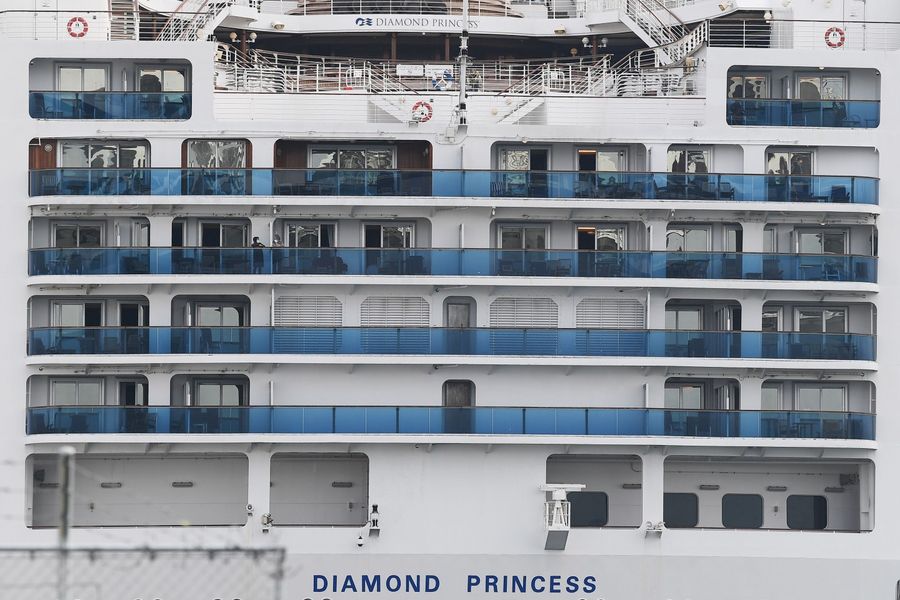 The Diamond Princess cruise ship, with around 3,600 people quarantined onboard due to fears of Covid-19, is seen at the Daikoku Pier Cruise Terminal in Yokohama port on 14 February 2020. (Charly Triballeau/AFP)
