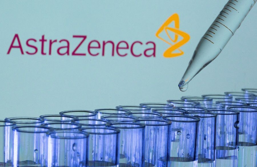 Test tubes are seen in front of a displayed AstraZeneca logo in this illustration taken on 21 May 2021. (Dado Ruvic/Illustration/Reuters)