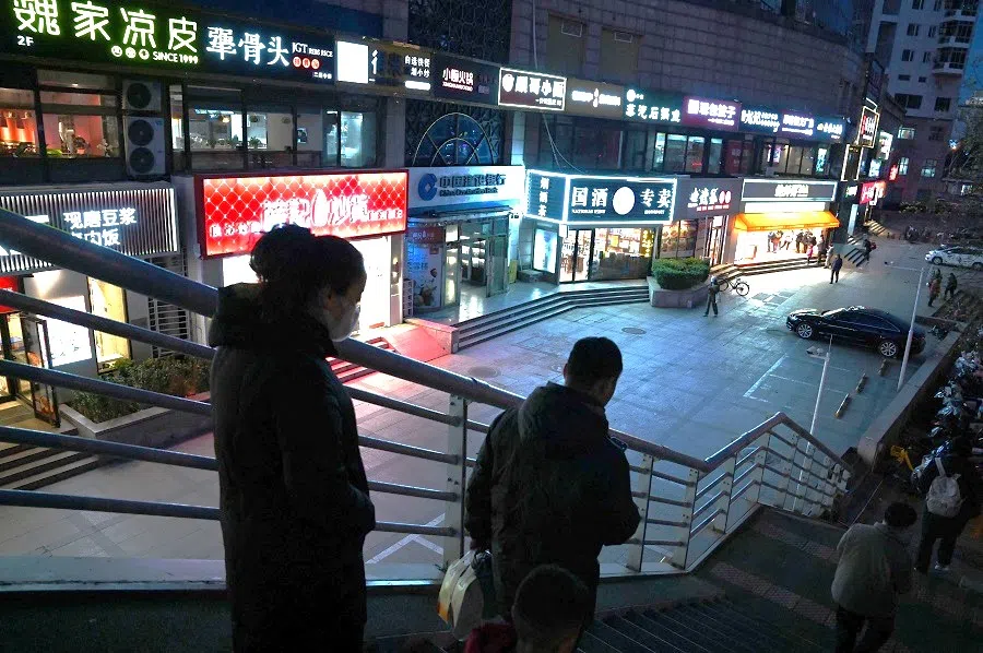 People walk down from a pedestrian overpass in Beijing, China, on 6 December 2024. (Greg Baker/AFP)
