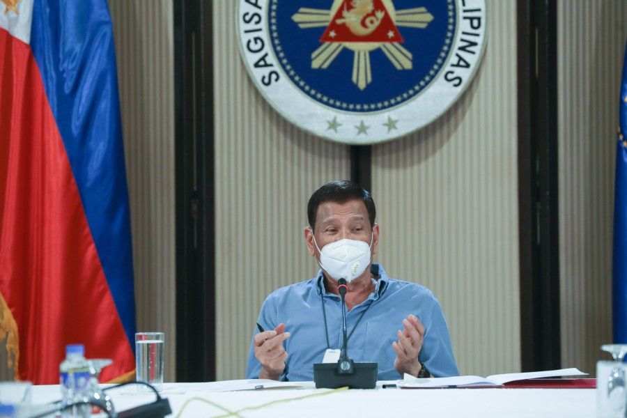 This photo taken April 8, 2020 and received from the Presidential Photo Division on April 9, Philippine President Rodrigo Duterte, wearing a face mask, presides over a meeting with members of the inter-Agency Task Force on the Emerging Infectious Diseases (IATF-EID) in Malacanang Palace in Manila. (Toto Lozano/Presidential Photo Division/AFP)