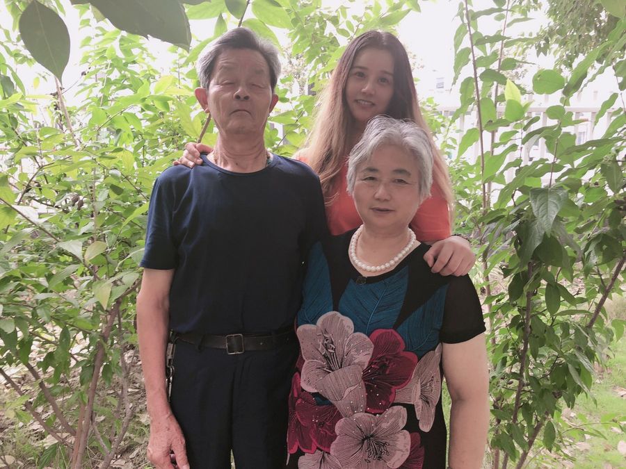 Tang Jinglin, his wife, and his daughter, now city-dwellers. (Photo: Tang Jinglin)