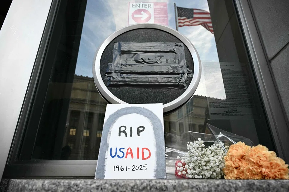Tributes are placed beneath the covered seal of the US Agency for International Development (USAID) at their headquarters in Washington, DC, on 7 February 2025. (Mandel Ngan/AFP)