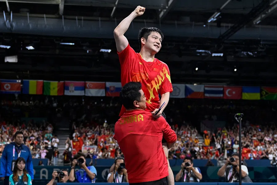 The People’s Republic of China’s Fan Zhendong (up) celebrates after winning the men’s table tennis singles gold medal match against Sweden’s Truls Moregard at the Paris 2024 Olympic Games, South Paris Arena in Paris, France, on 4 August 2024. (Wang Zhao/AFP)