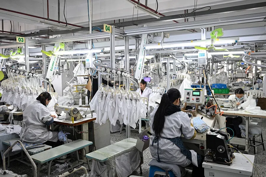 Employees work on a shirt production line at a clothing factory in Suqian, in eastern China’s Jiangsu province on 22 November 2024. (AFP)