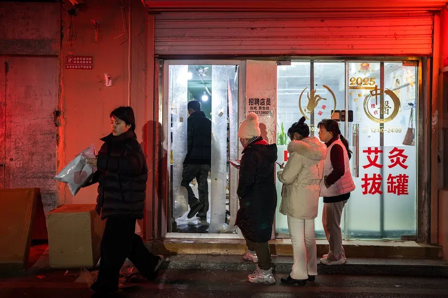 Sister Chen in a queue to collect courier packages.