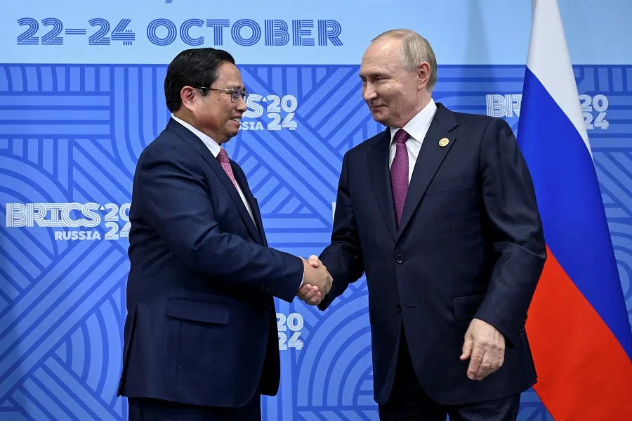 Russian President Vladimir Putin shakes hands with Vietnamese Prime Minister Pham Minh Chinh during a meeting on the sidelines of the BRICS summit in Kazan, Russia, on 24 October 2024. (Alexander Nemenov/Reuters)