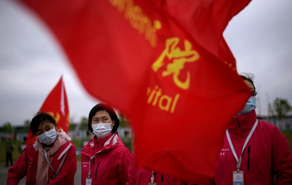 Staff members wearing face masks are seen at the Leishenshan Hospital, a makeshift hospital for treating patients infected with the Covid-19 coronavirus, in Wuhan, Hubei, China on 11 April 2020. (Aly Song/Reuters)