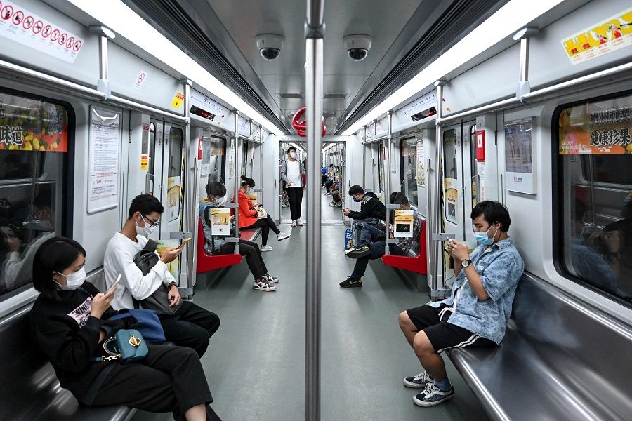 This photo taken on 30 November 2022 shows people inside a subway train in Haizhu district, Guangzhou city, Guangdong province, China, following the easing of Covid-19 restrictions in the city. (CNS/AFP)
