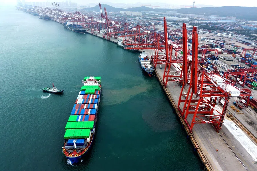 A ship is moved into position at the container terminal of the port in Qingdao, in China’s eastern Shandong province on 11 October 2025. (AFP)