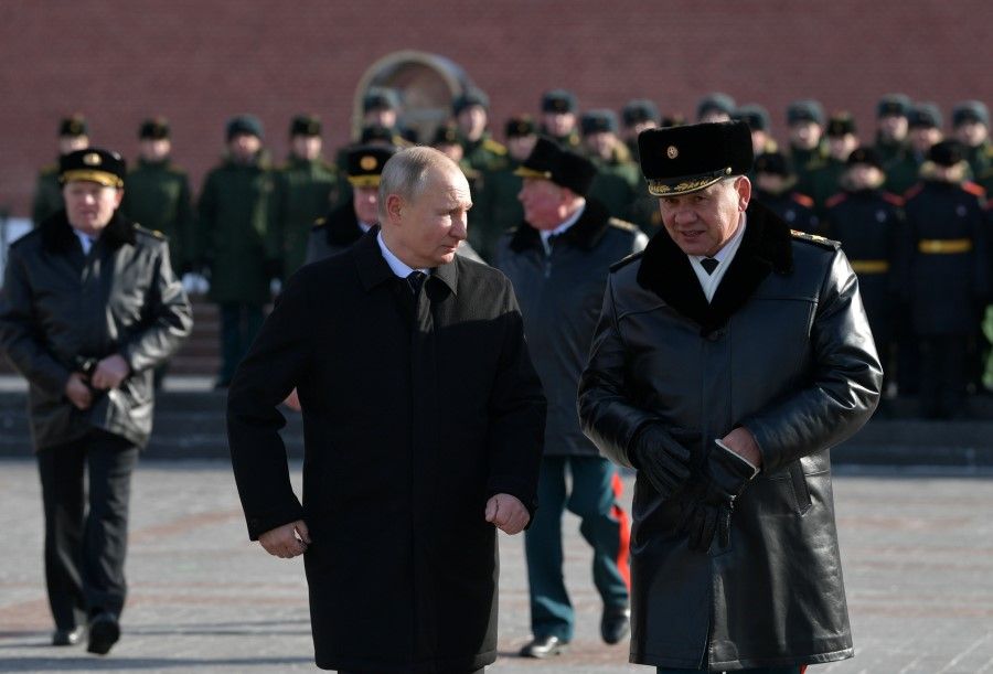 Russia's President Vladimir Putin and Defence Minister Sergei Shoigu attend a wreath-laying ceremony at the Tomb of the Unknown Soldier by the Kremlin Wall to mark the Defender of the Fatherland Day in Moscow, Russia, 23 February 2021. (Sputnik/Alexei Druzhinin/Kremlin via Reuters)