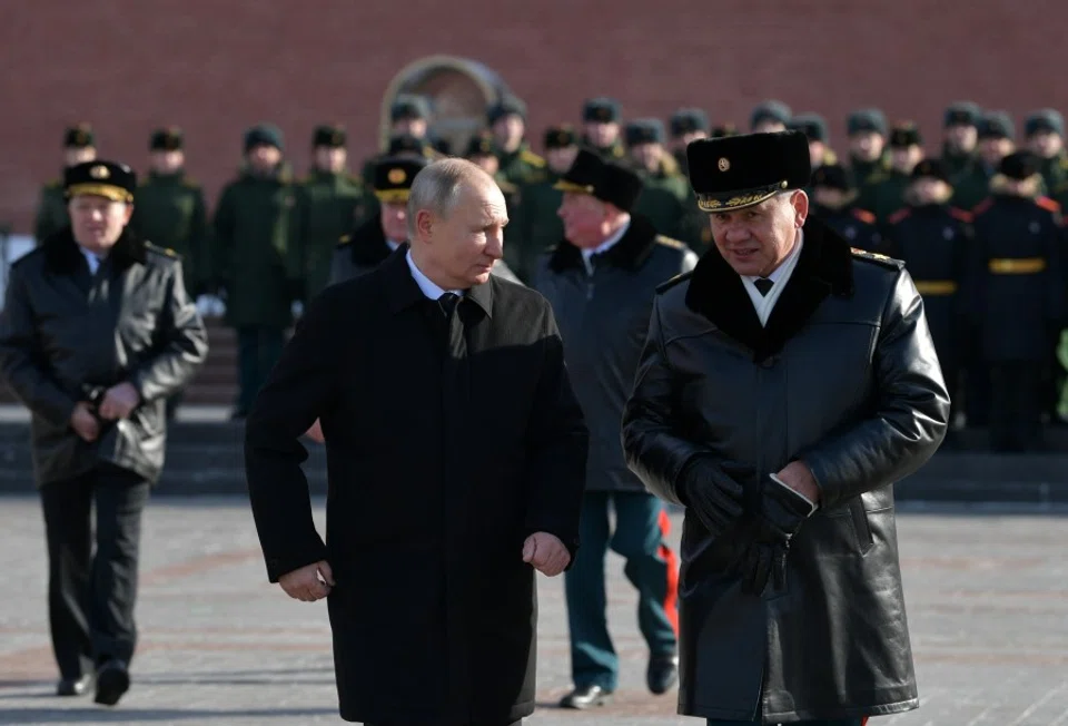 Russia's President Vladimir Putin and Defence Minister Sergei Shoigu attend a wreath-laying ceremony at the Tomb of the Unknown Soldier by the Kremlin Wall to mark the Defender of the Fatherland Day in Moscow, Russia, 23 February 2021. (Sputnik/Alexei Druzhinin/Kremlin via Reuters)