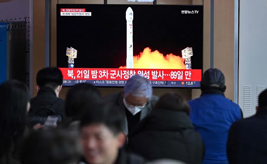 People watch a television screen showing a news broadcast with a picture of North Korea's latest satellite-carrying rocket launch, at a railway station in Seoul, South Korea, on 22 November 2023. (Jung Yeon-je/AFP)