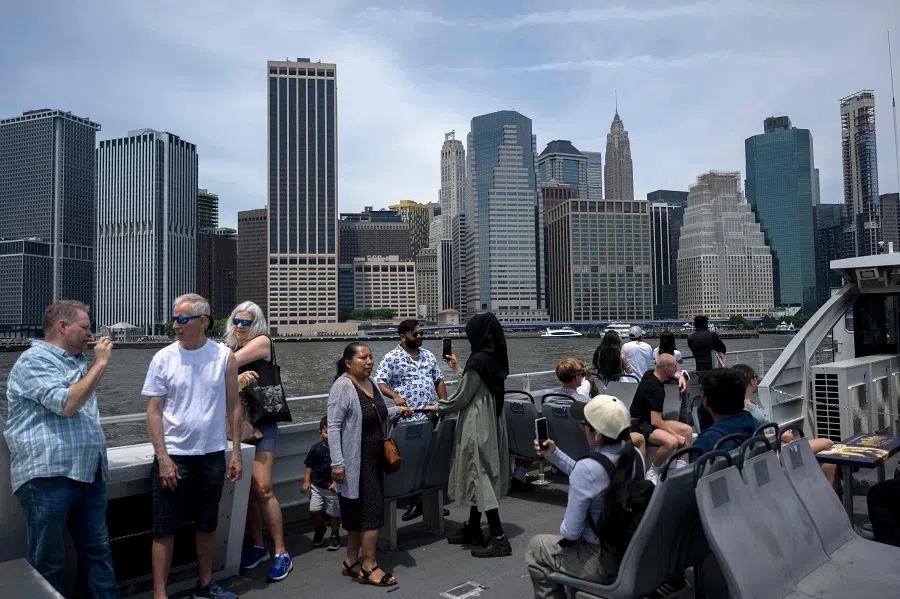 People ride the ferry from Brooklyn to Manhattan in New York City on 4 June 2024.  (Angela Weiss/AFP)