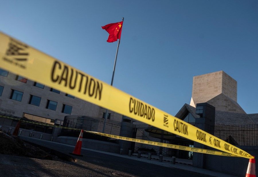 Caution tape is seen near the Chinese embassy as activists hold a demonstration calling on Chinese President Xi Jinping to "allow safe passage to North Koreans detained in China" in Washington, DC on 24 September 2021. (Andrew Caballero-Reynolds/AFP)