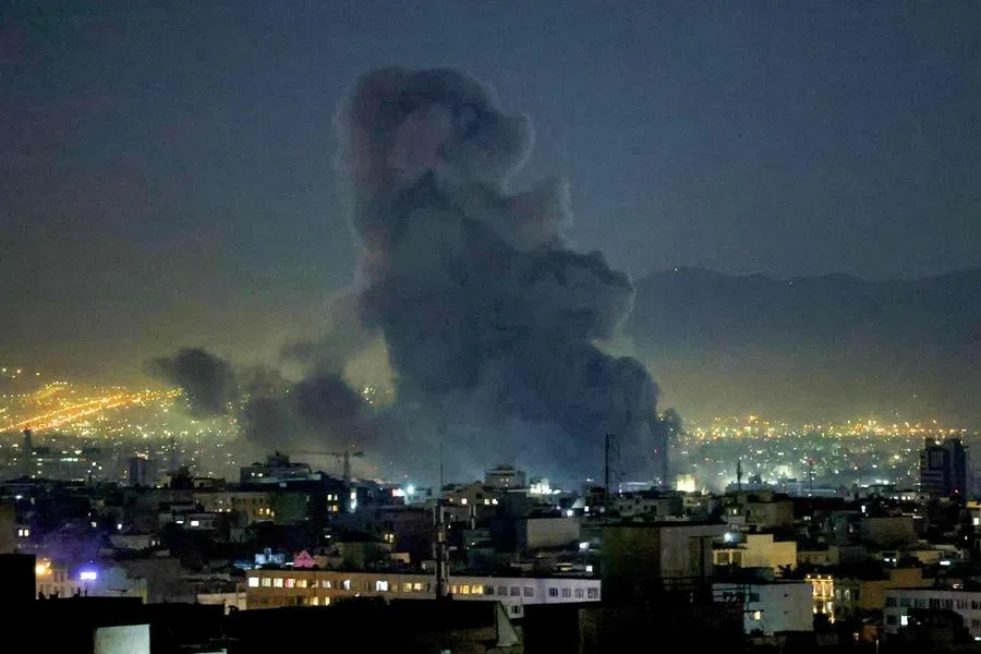 Smoke plumes rise following missile strikes in Tehran on 1 March 2026.