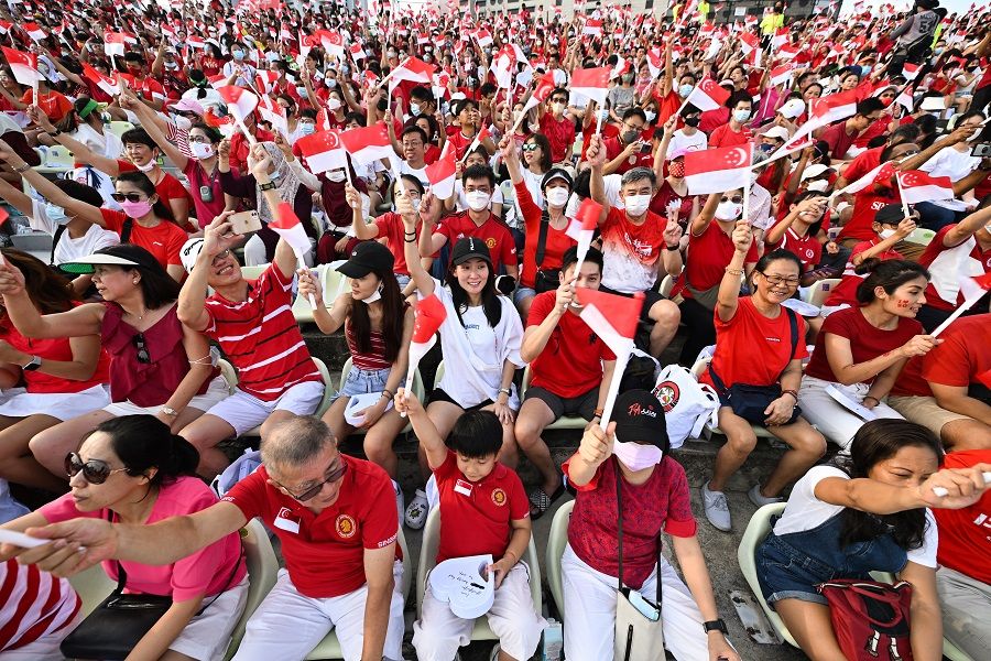 A sea of red and white as Singaporeans dressed in the colours of the national flag gathered at The Float @ Marina Bay to enjoy the National Day Parade 2022, 9 August 2022. (SPH Media)