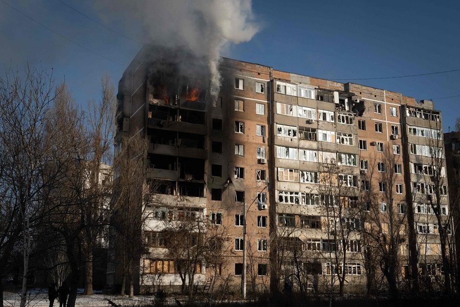 This photograph taken on 8 February 2023 shows part of the building burning after shelling in the city of Avdiivka, Ukraine, amid the Russian invasion of Ukraine. (Yasuyoshi Chiba/AFP)