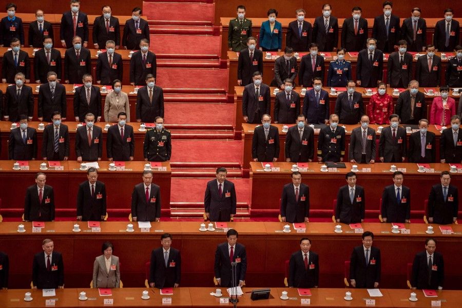 This file photo taken on 11 March 2021 shows China's President Xi Jinping (centre) singing the national anthem with other leaders and delegates during the closing session of the National People's Congress at the Great Hall of the People in Beijing. (Nicolas Asfouri/AFP)