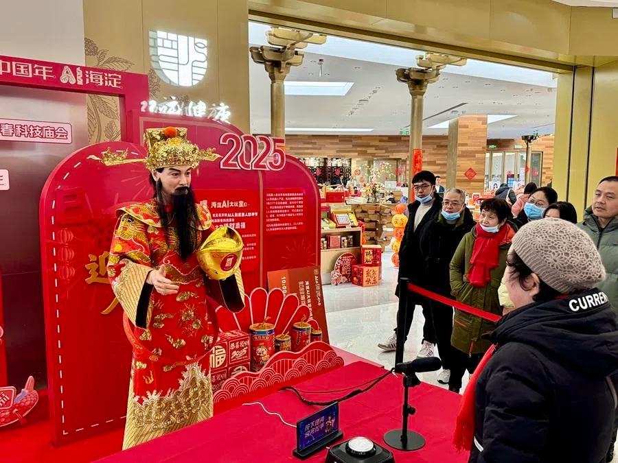 At a Beijing's temple fair on 3 February 2025, the Chinese traditional deity Cai Shen Ye (God of Wealth) is a humanoid robot that takes questions from the public and dispenses advice and lucky sayings. (SPH Media)