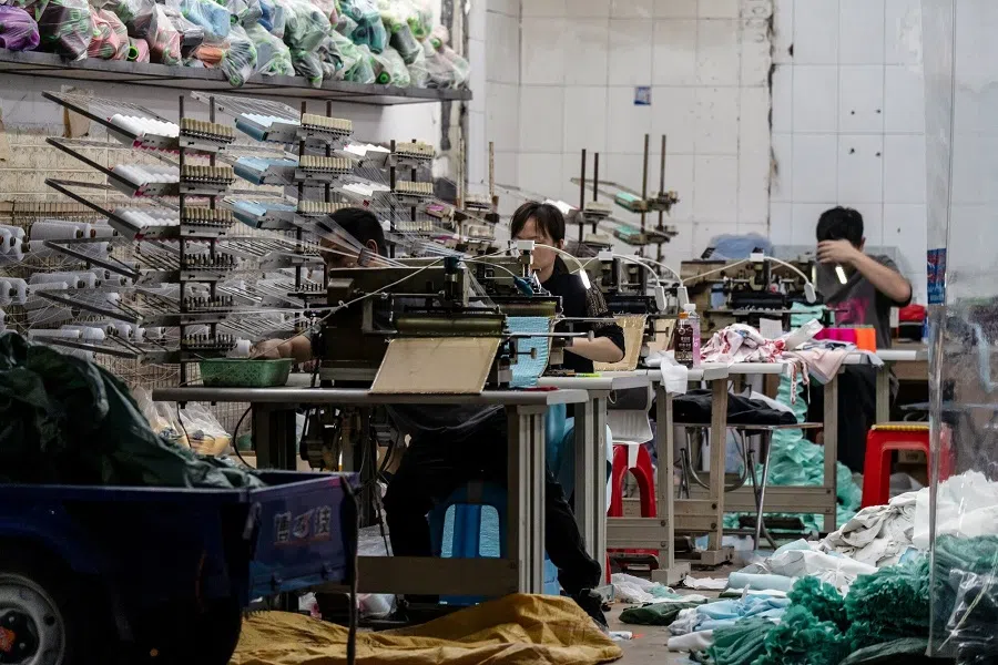 Workers operate sewing machines at a garment workshop in Guangzhou, Guangdong province, China, on 7 April 2025. (Qilai Shen/Bloomberg)