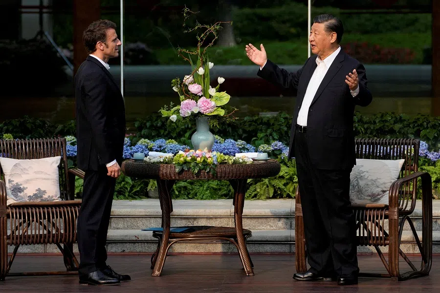 Chinese President Xi Jinping (right) and French President Emmanuel Macron talk prior to a tea ceremony at the Guandong province governor's residence, in Guangzhou, China, 7 April 2023. (Thibault Camus/Pool via Reuters/File Photo)