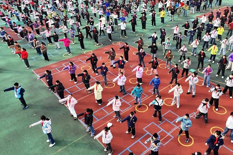 Primary school students take part in a physical education class at a school in Lianyungang, Jiangsu province, China, on 20 November 2025. (AFP)