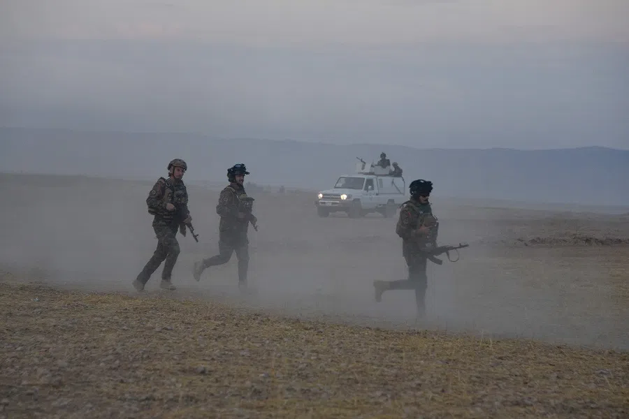 A joint force of the Iraqi Army and Hashed al-Shaabi (Popular Mobilisation Forces) paramilitaries patrols an area in the Qayyara region in Iraq’s northern Nineveh province, next to the Kurdish autonomous region of Arbil, during a security operation to search for reported remnants of the Islamic State (IS) jihadist group on 31 October 2024. (Zaid Al-Obeidi/AFP)