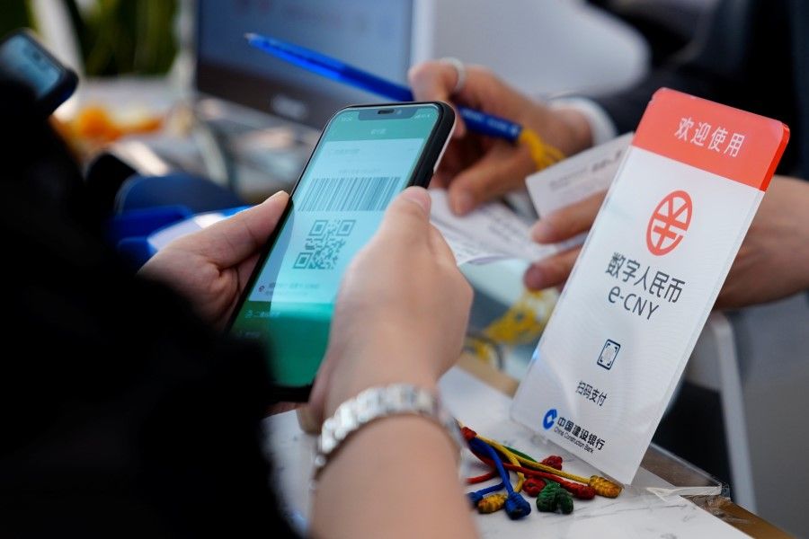 A sign indicating digital yuan, also referred to as e-CNY, is pictured at a shopping mall in Shanghai, China, 5 May 2021. (Aly Song/Reuters)
