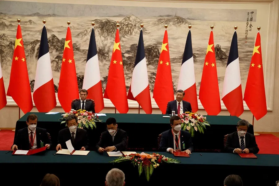 Airbus CEO Guillaume Faury (left) and EDF CEO Luc Remont (second from right) sign agreements with their Chinese counterparts in the presence of French President Emmanuel Macron (back, left) and Chinese President Xi Jinping (back, right) during the state visit in Beijing, China, on 6 April 2023. (Ludovic Marin/AFP)