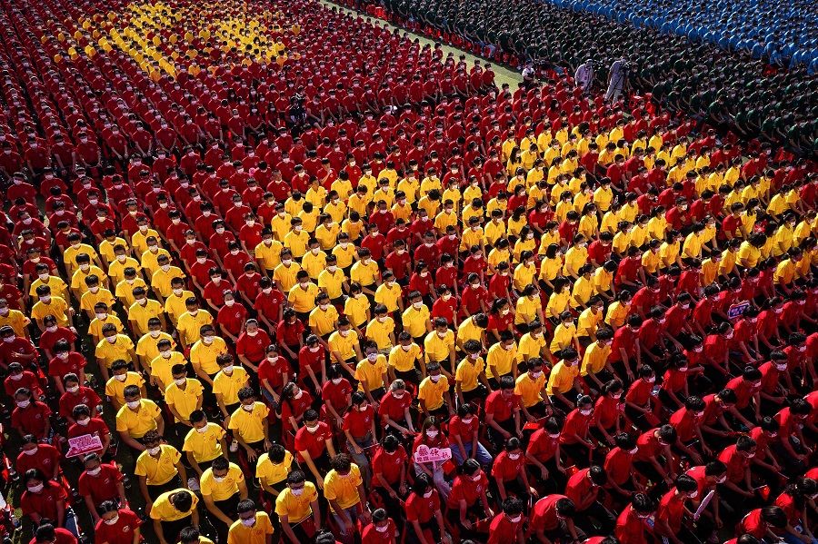 University students form an image to mark the 100th anniversary of the founding of the Communist Party of China during an opening ceremony of the new semester in Wuhan, Hubei province, China, on 10 September 2021. (STR/AFP)