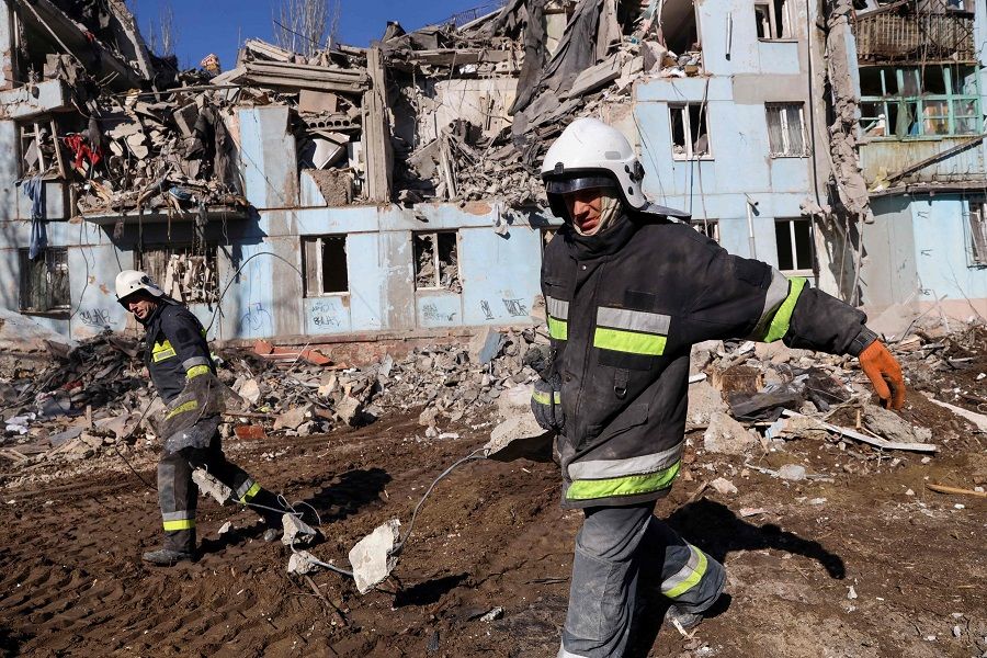 Ukrainian rescuers remove debris from the five-storey residential building destroyed after a missile strike in Zaporizhzhia, Ukraine, on 2 March 2023, amid the Russian invasion of Ukraine. (Katerina Klochko/AFP)