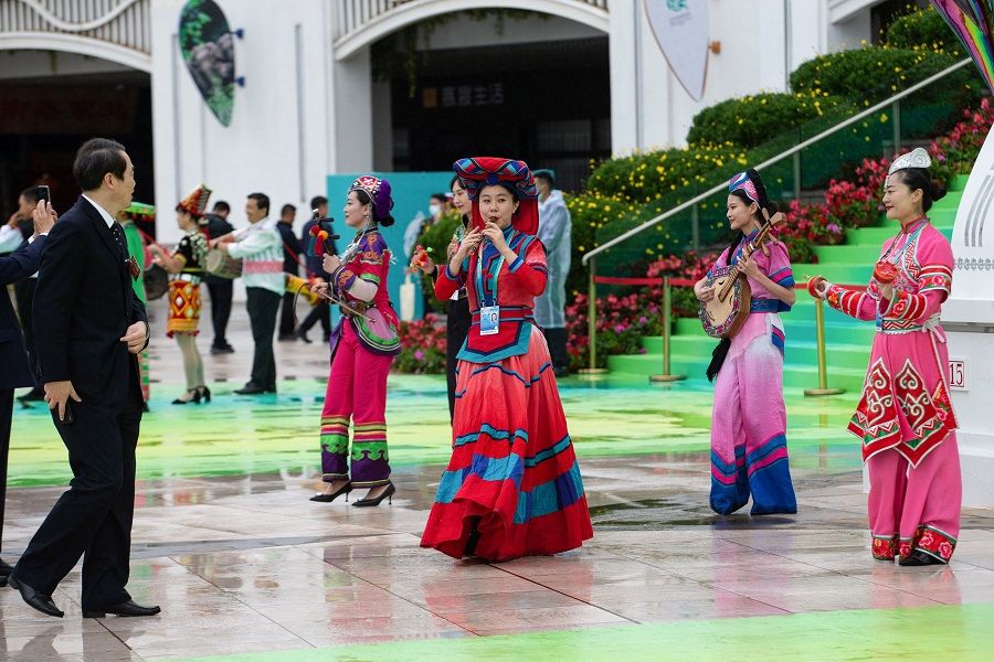 Dancers perform outside the venue of the UN Biodiversity Conference (COP 15) in Kunming, Yunnan province, China, on 11 October 2021. (STR/AFP)