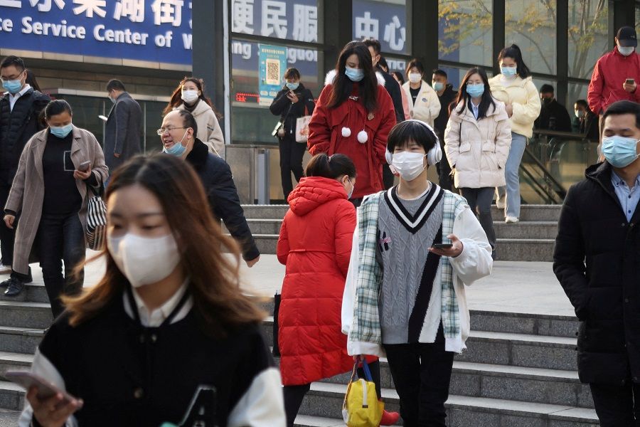People walk out of a subway station during morning rush hour in Wuchang district, Wuhan, Hubei province, China, 9 December 2022. (Martin Pollard/File Photo/Reuters)