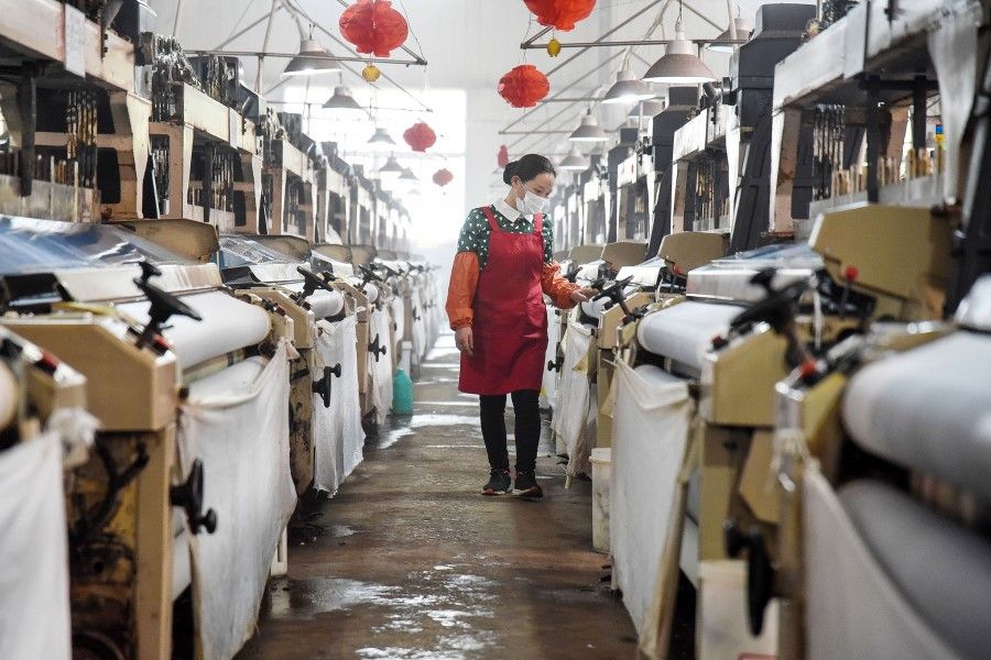 This photo taken on 29 April 2020 shows an employee working at a textile factory in Handan in China's northern Hebei province. (STR/AFP)