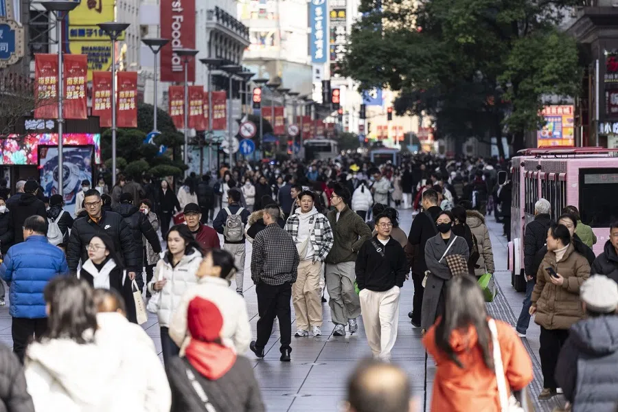 Shoppers walk down Nanjing East Road, a busy retail street, in Shanghai, China, on 4 January 2025. (Qilai Shen/Bloomberg)
