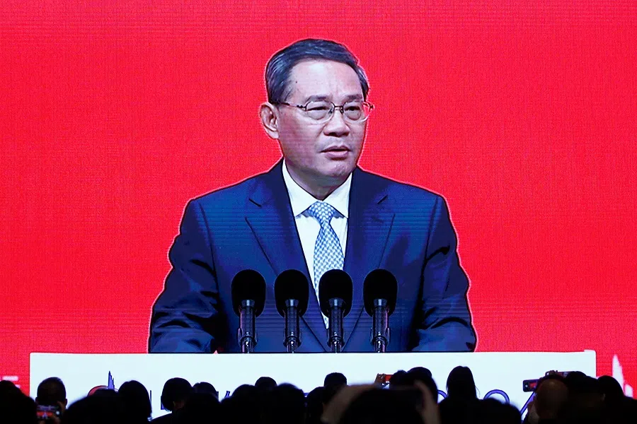 A giant screen shows Chinese Premier Li Qiang delivering a speech at the opening ceremony of China Development Forum (CDF) 2024, in Beijing, China, on 24 March 2024.  (Jing Xu/Reuters)