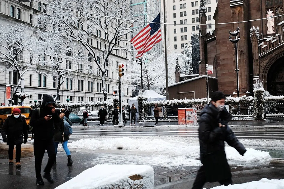 People walk through the snow in Manhattan on 7 January 2022 in New York City, US. (Spencer Platt/Getty Images/AFP)
