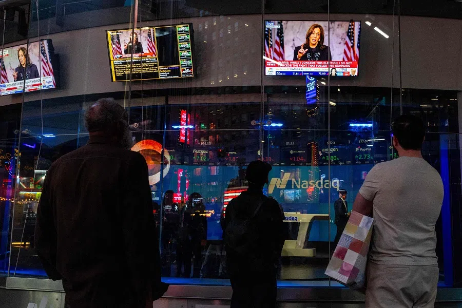 People watch US Vice-President Harris’s concession speech in Times Square with screens reflected on the glass of the Nasdaq building on 6 November 2024 in New York City, US. (Alex Kent/Getty Images/AFP)