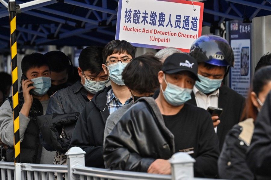 People queue up to be tested as a measure against the Covid-19 coronavirus at the Shanghai Jin'an Central Hospital, in Shanghai on 11 March 2022. (Hector Retamal/AFP)