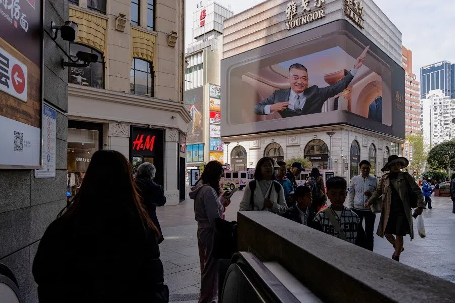 Pedestrians pass a 3D advertising billboard at the Nanjing Road shopping area in Shanghai, China, on 3 April 2025.