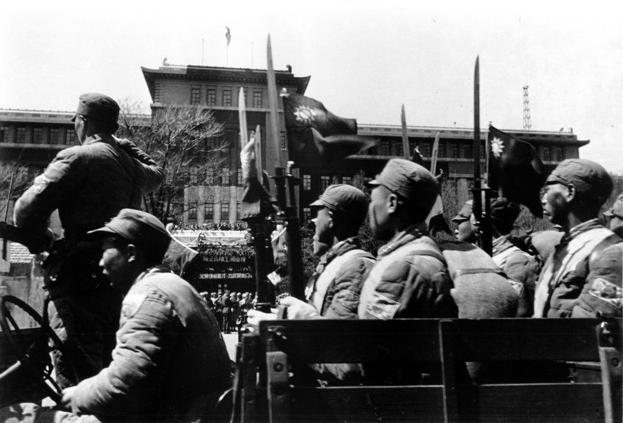 The New 1st Army, reputedly the most elite Chinese military unit of the Kuomintang, marches proudly past the podium under the inspection of Du Yuming, the security commander for northeast China, April 1946.