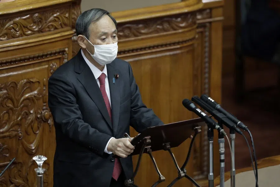 Yoshihide Suga, Japan's prime minister, wears a protective face mask as he speaks during a plenary session at the upper house of parliament in Tokyo, Japan, on 30 November 2020.(Kiyoshi Ota/Bloomberg)